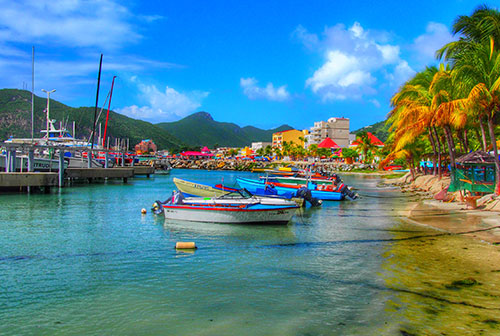 Tourist and commercial boats anchored off Caribbean beach